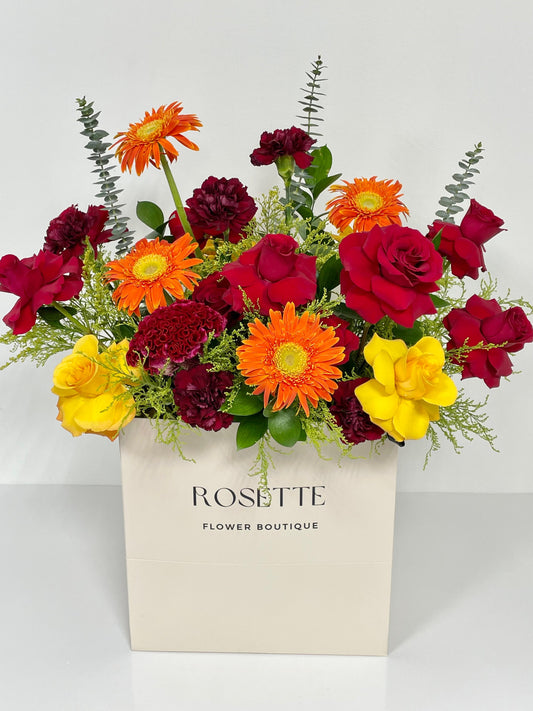 ORANGE GERBERA PAPER BAG ARRANGEMENT